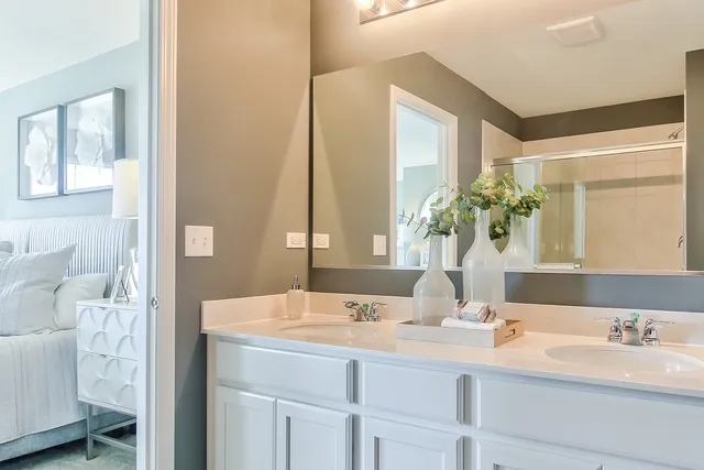 a bathroom with a double vanity sink and a mirror