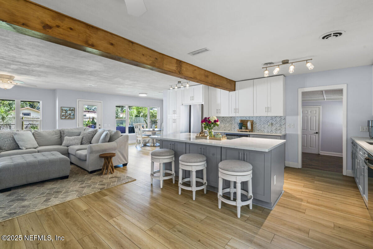 1901 Tanglewood Road Jacksonville Beach, FL 32250 - Photo 13 of 48 a living room with stainless steel appliances granite countertop furniture wooden floor and a view of kitchen