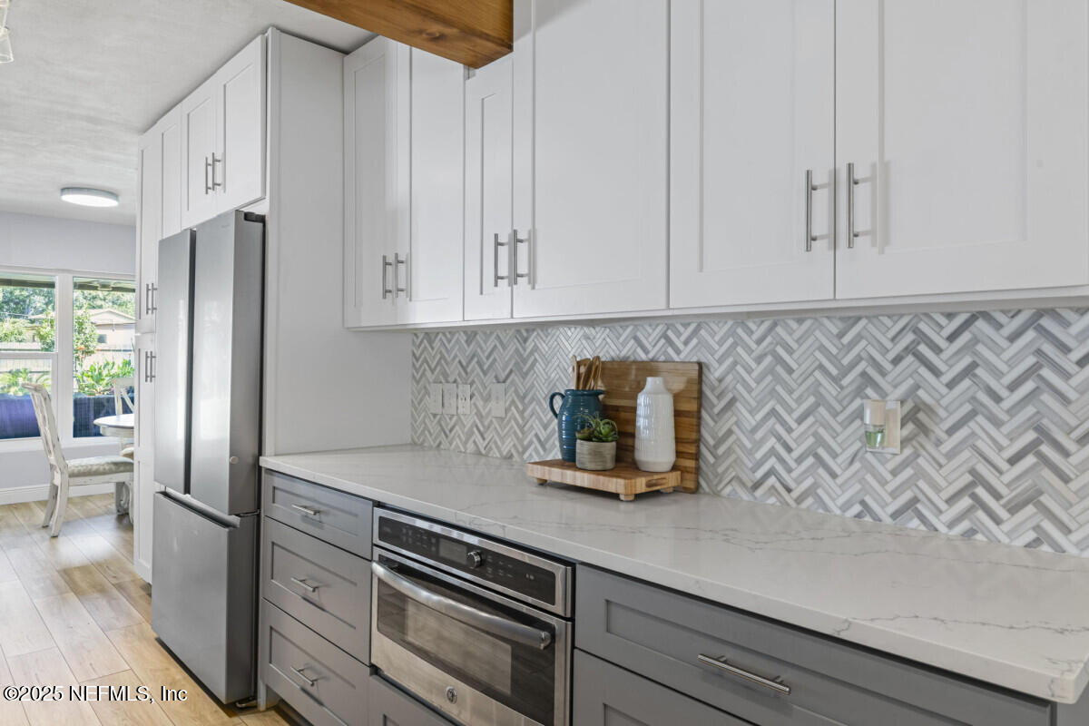 1901 Tanglewood Road Jacksonville Beach, FL 32250 - Photo 14 of 48 a kitchen with a white cabinets and white appliances