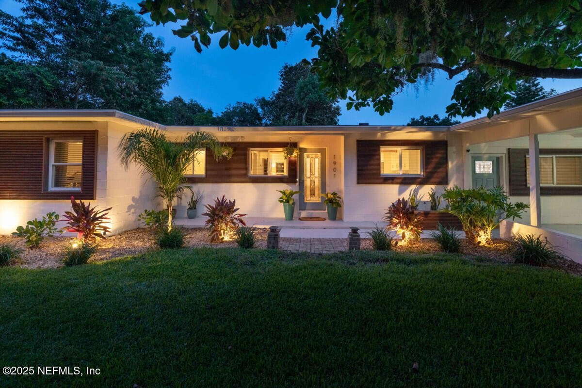1901 Tanglewood Road Jacksonville Beach, FL 32250 - Photo 15 of 48 a front view of house with a garden and patio