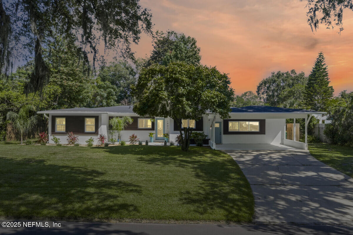 1901 Tanglewood Road Jacksonville Beach, FL 32250 - Photo 2 of 48 a front view of a house with a garden