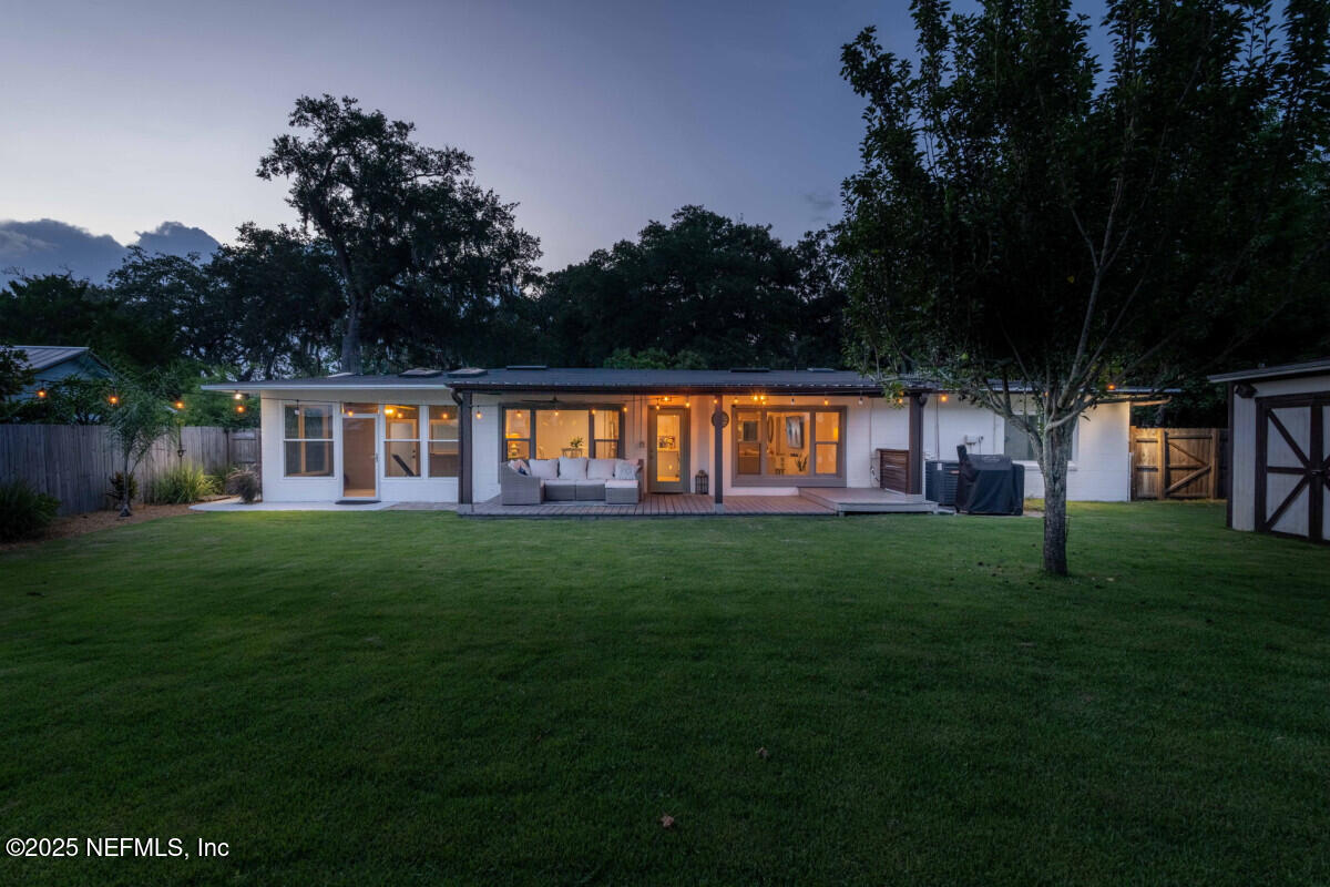 1901 Tanglewood Road Jacksonville Beach, FL 32250 - Photo 21 of 48 a view of a big yard with plants and large trees