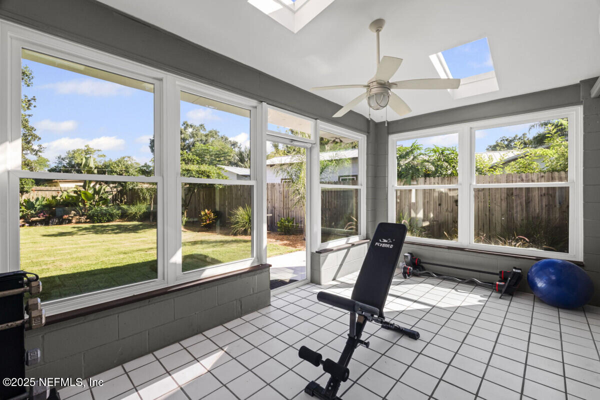 1901 Tanglewood Road Jacksonville Beach, FL 32250 - Photo 22 of 48 a living room with furniture and a floor to ceiling window