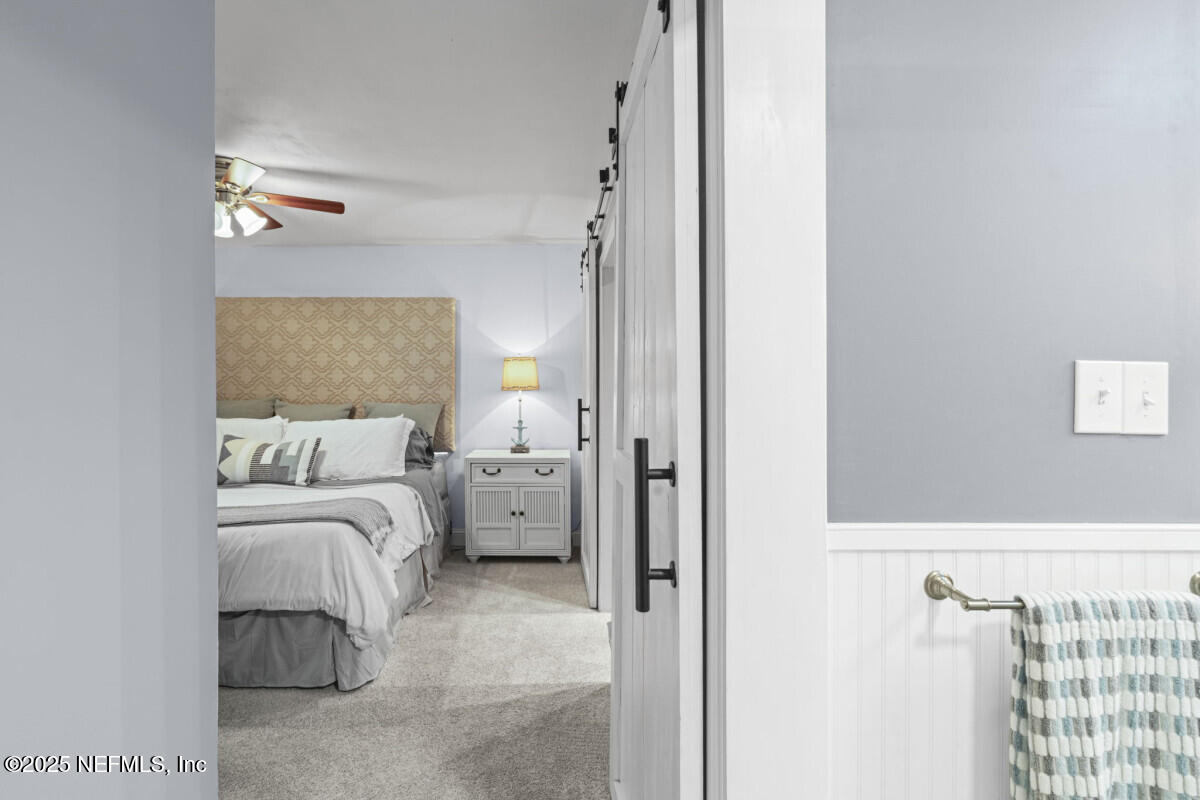 1901 Tanglewood Road Jacksonville Beach, FL 32250 - Photo 23 of 48 a bedroom with a bed and a night stand