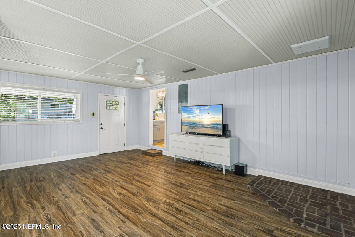 1901 Tanglewood Road Jacksonville Beach, FL 32250 - Photo 24 of 48 a view of room with wooden floor and flat screen tv