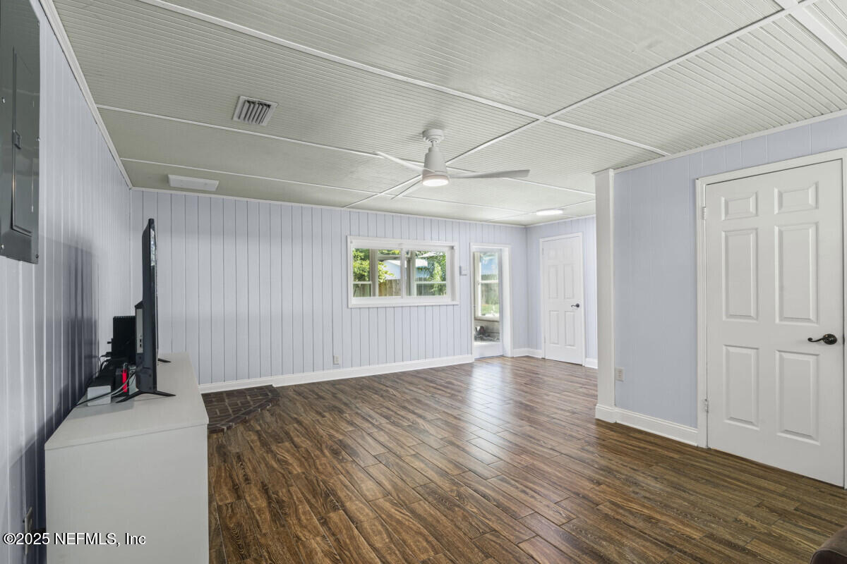 1901 Tanglewood Road Jacksonville Beach, FL 32250 - Photo 26 of 48 a view of an empty room with a window and wooden floor