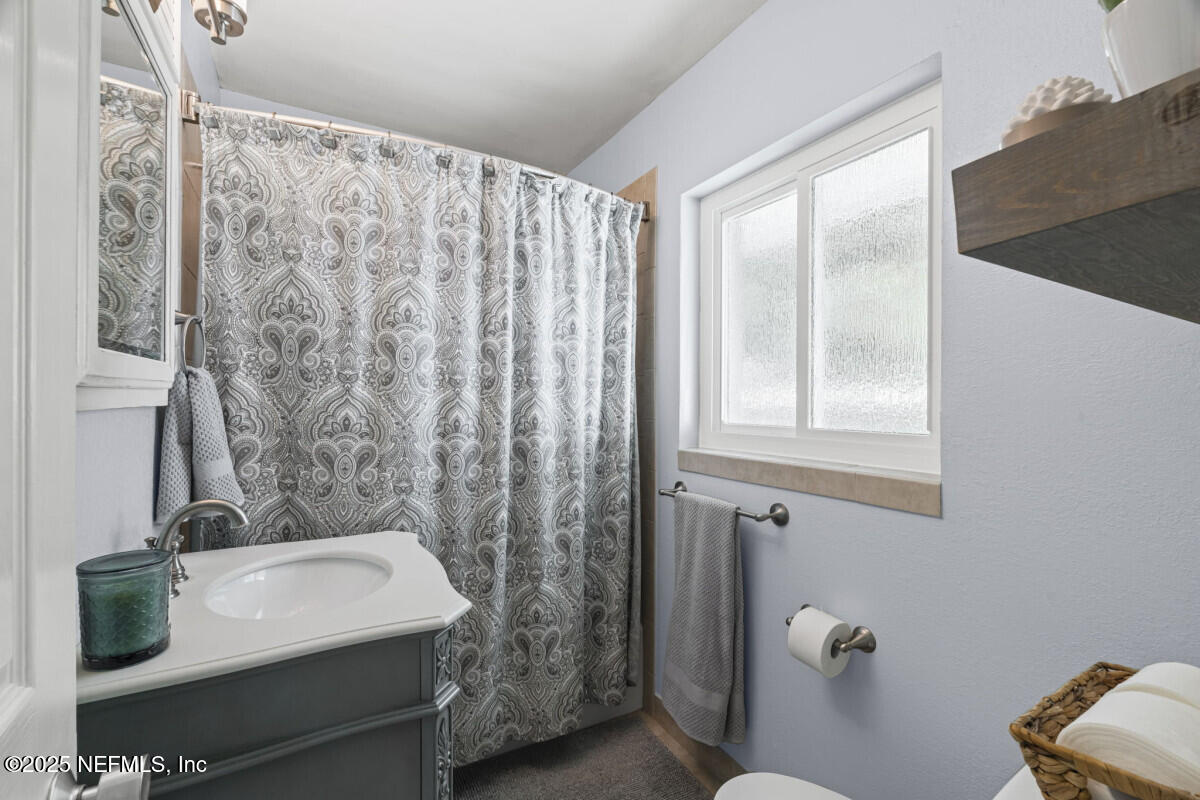 1901 Tanglewood Road Jacksonville Beach, FL 32250 - Photo 27 of 48 a bathroom with a sink and a mirror