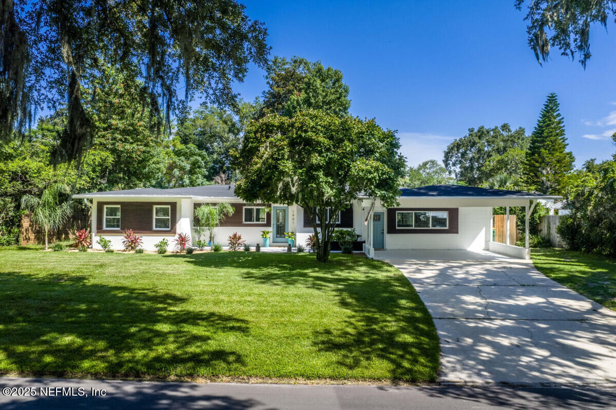 1901 Tanglewood Road Jacksonville Beach, FL 32250 - Photo 3 of 48 a front view of a house with a garden