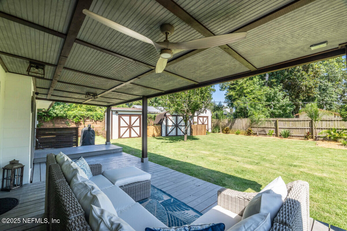 1901 Tanglewood Road Jacksonville Beach, FL 32250 - Photo 34 of 48 a view of a patio with a table chairs and a backyard