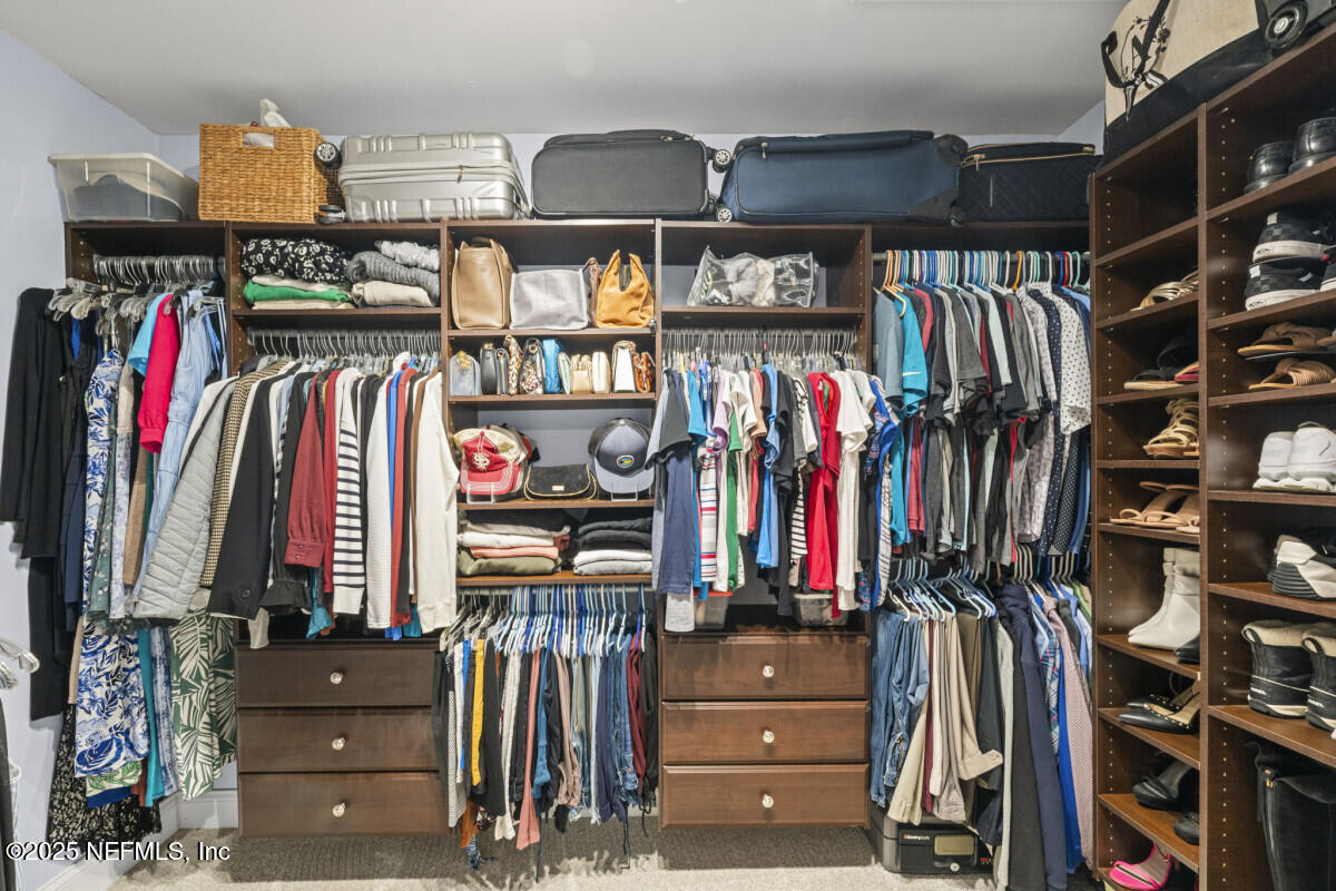 1901 Tanglewood Road Jacksonville Beach, FL 32250 - Photo 39 of 48 a view of walk in closet with clothes and shoes
