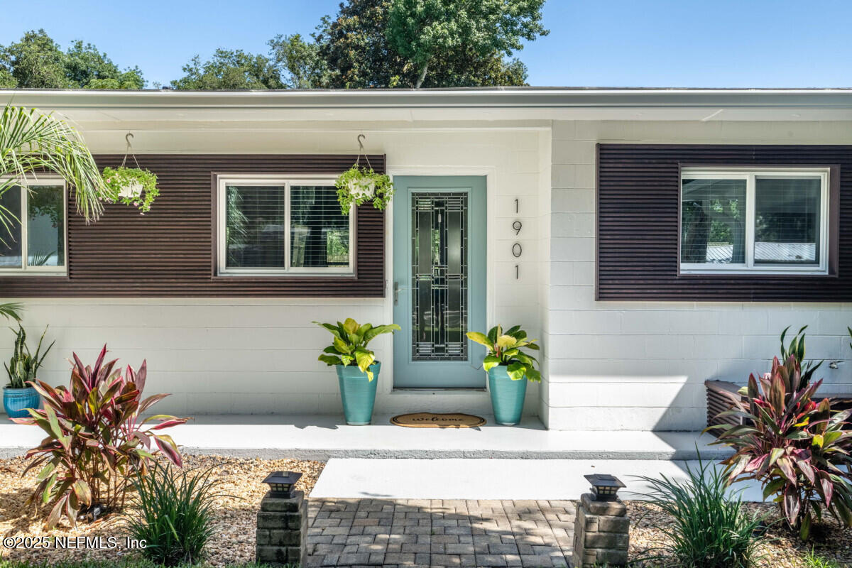 1901 Tanglewood Road Jacksonville Beach, FL 32250 - Photo 4 of 48 a potted plant sitting in front of a house