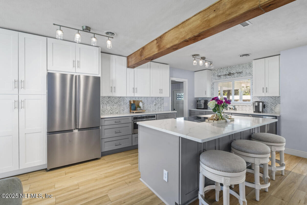1901 Tanglewood Road Jacksonville Beach, FL 32250 - Photo 7 of 48 a kitchen with kitchen island a sink stove and refrigerator