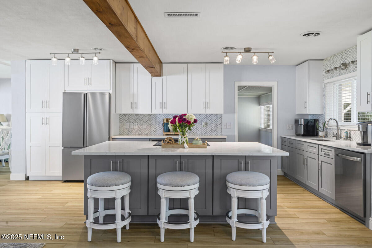 1901 Tanglewood Road Jacksonville Beach, FL 32250 - Photo 8 of 48 a kitchen with cabinets table and chairs