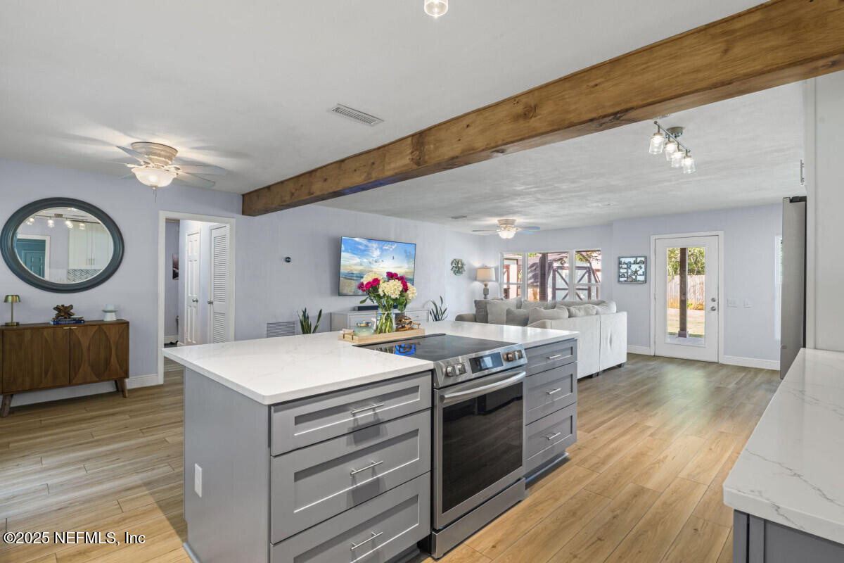 1901 Tanglewood Road Jacksonville Beach, FL 32250 - Photo 9 of 48 a kitchen with a stove and a table