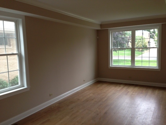 246 Highland Road Willowbrook, IL 60527 - Photo 3 of 6 an empty room with wooden floor and windows