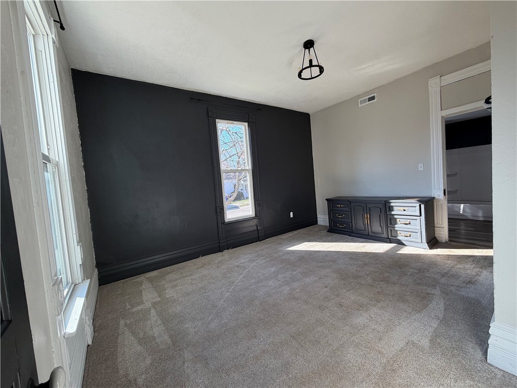 230 West Decatur Street Eaton, OH 45320 - Photo 11 of 22 This inviting bedroom features soft carpeting and ample natural light, creating a comfortable living space.