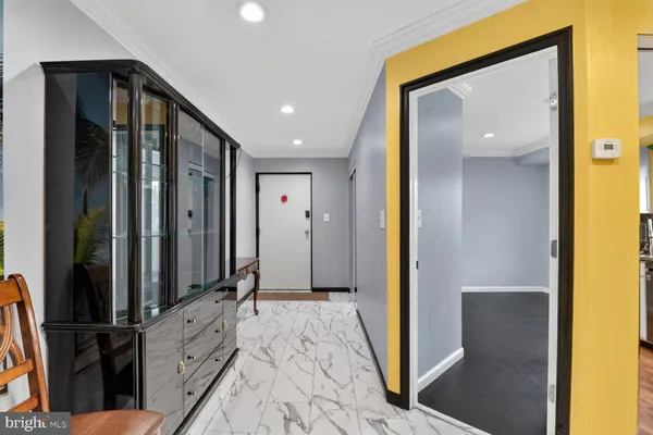 a kitchen with a refrigerator stainless steel appliances wooden floor cabinets and a counter top space