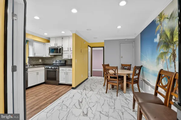 a view of a dining room with furniture and chandelier