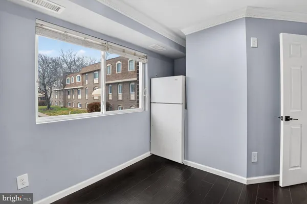 a view of a hallway with wooden floor and closet