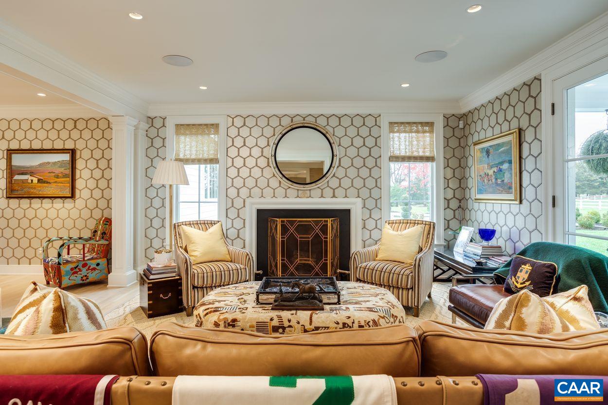 4545 Louisa Road Keswick, VA 22947 - Photo 15 of 51 a living room with furniture a large window and a fireplace