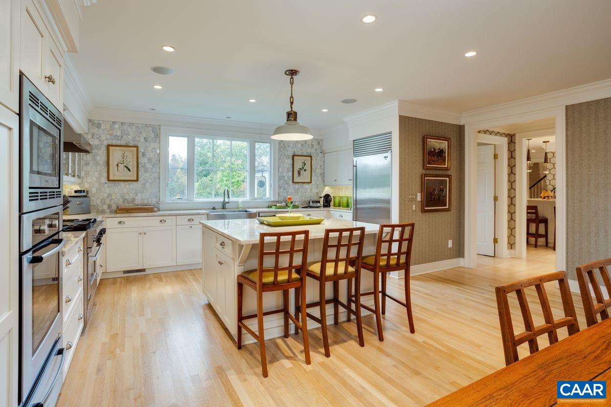 4545 Louisa Road Keswick, VA 22947 - Photo 20 of 51 a kitchen with stainless steel appliances a dining table chairs stove and cabinets