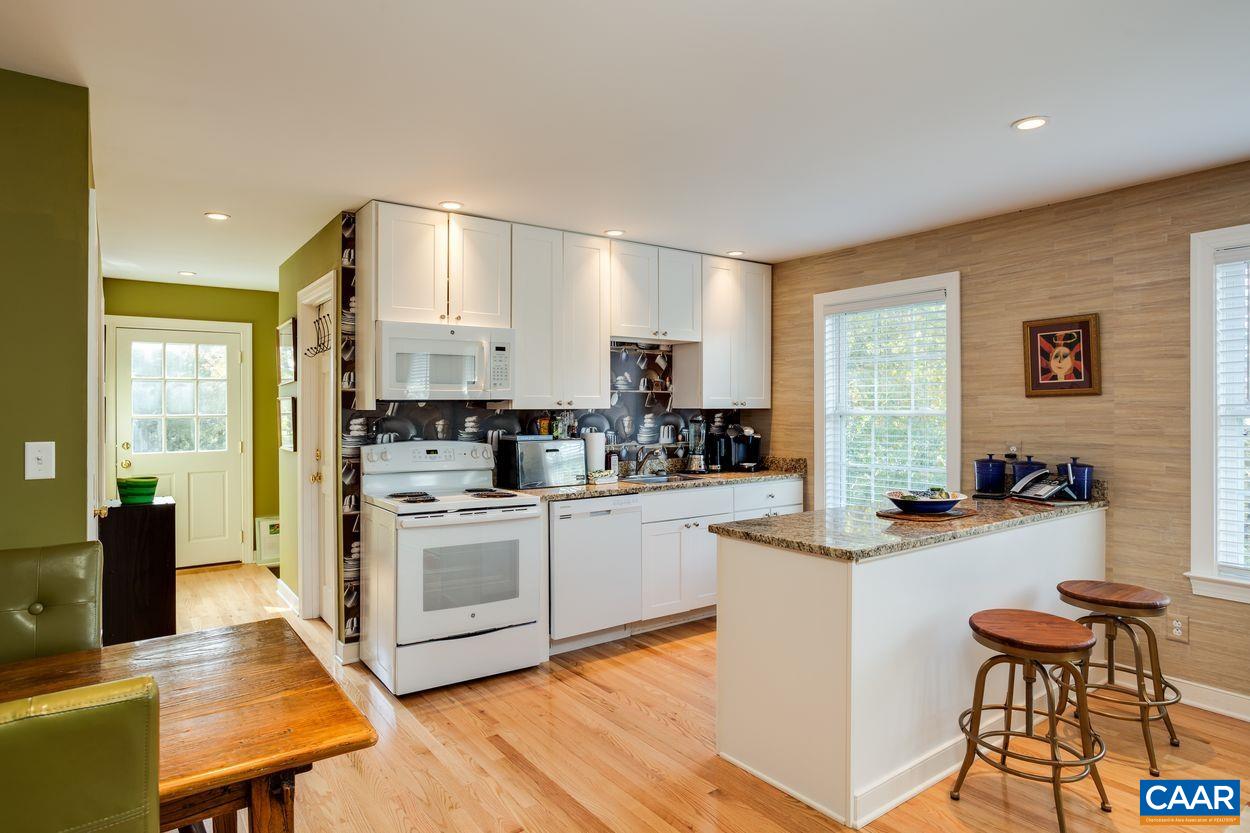 4545 Louisa Road Keswick, VA 22947 - Photo 45 of 51 a kitchen with white cabinets and white appliances