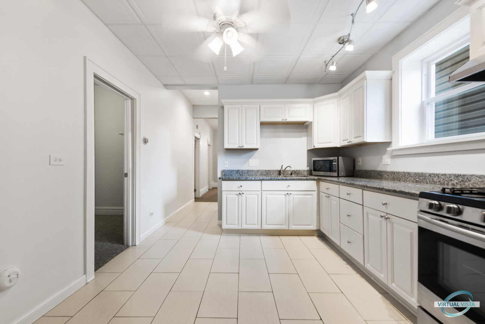 3510 South Union Avenue, Unit 1 Chicago, IL 60609 - Photo 8 of 18 a large kitchen with cabinets and stainless steel appliances