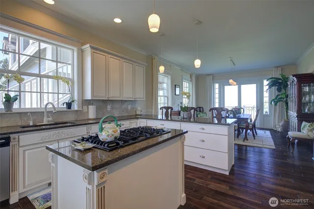 a kitchen with a counter space a sink appliances and cabinets