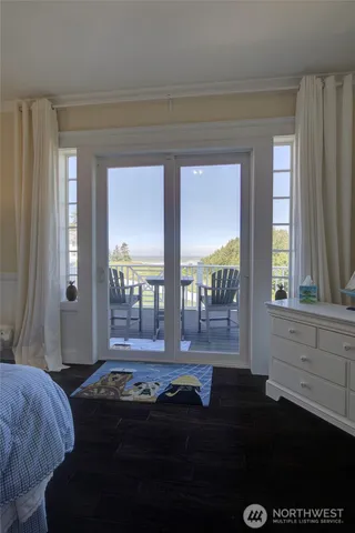 a living room with furniture and a floor to ceiling window