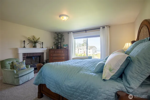a spacious bedroom with a balcony a bed and a fireplace