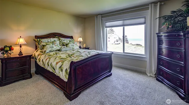 a large bed sitting in a bedroom next to a window