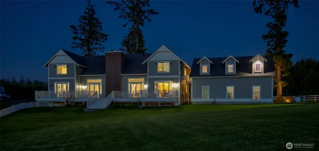 a front view of a house with a garden and yard