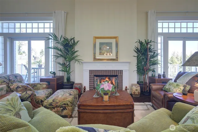 a living room with furniture fireplace and a large window