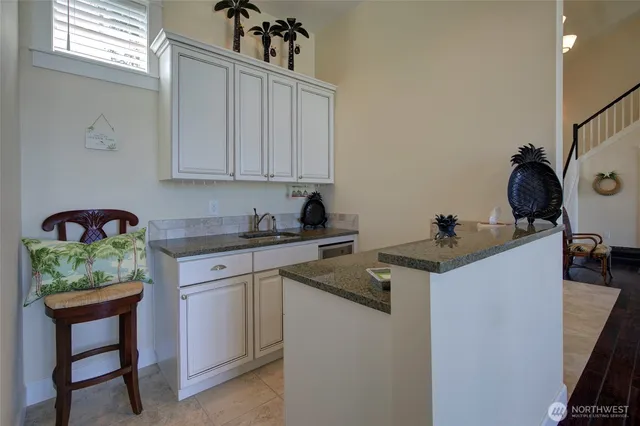 a kitchen with stainless steel appliances granite countertop a sink stove and cabinets