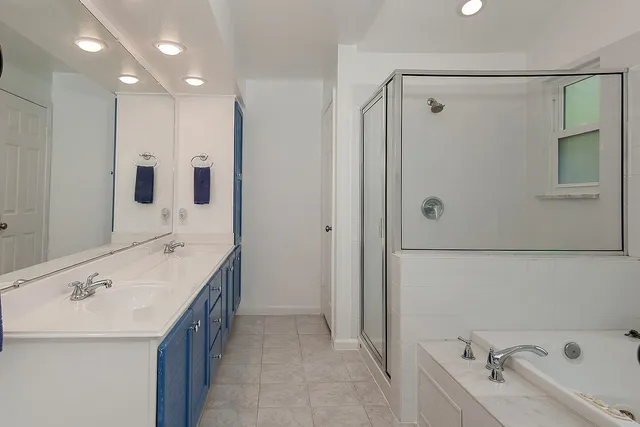 a bathroom with a bathtub and a shower