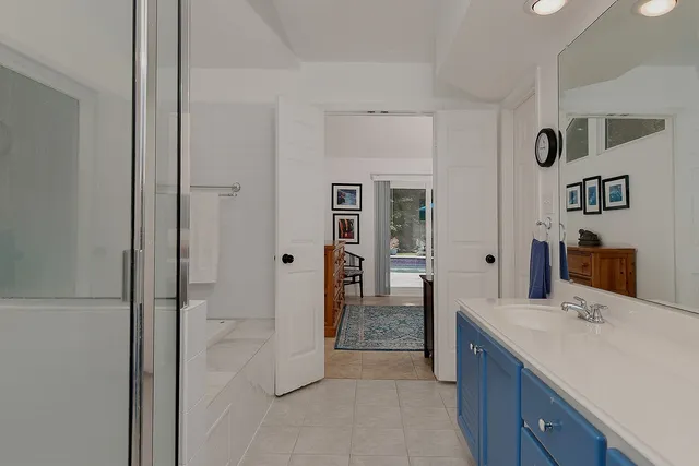 a bathroom with a bathtub and a shelf