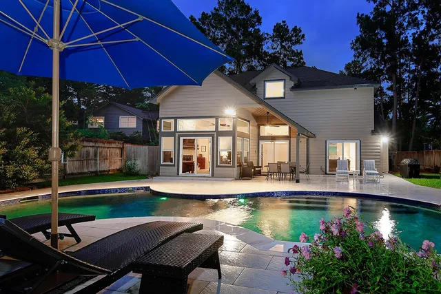 a view of a swimming pool with sitting area and furniture