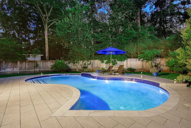 a view of a swimming pool with an outdoor space and seating area