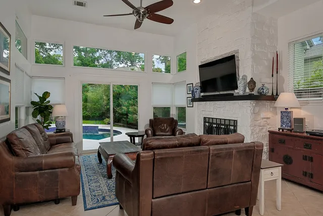 a living room with furniture a flat screen tv and a fireplace