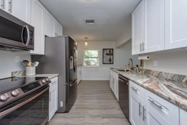 a kitchen with a sink stove and refrigerator