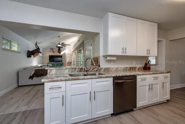 a kitchen with a sink stove and cabinets