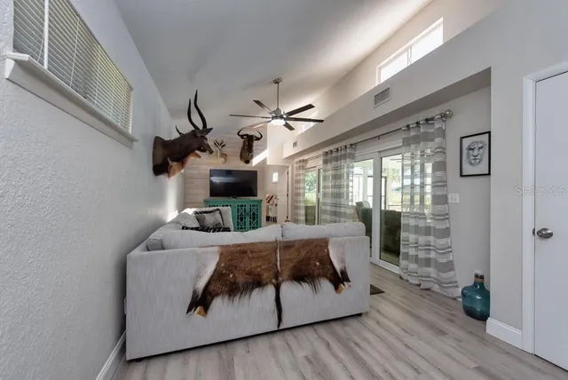 a living room with furniture and wooden floor