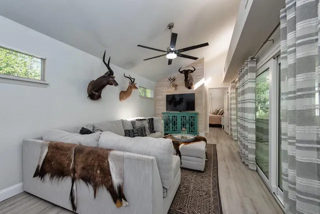 a bedroom with furniture and a large window