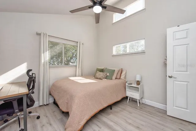 a bedroom with a bed and a chandelier