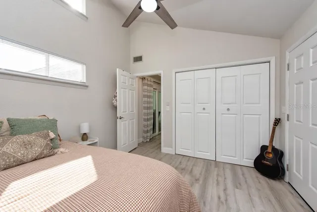 a bedroom with a bed and a window