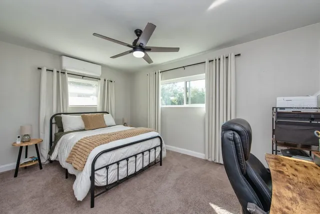 a bedroom with a bed a couch and a window