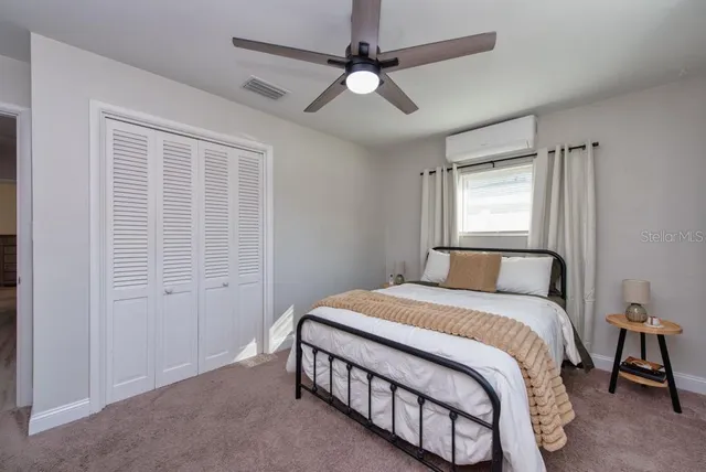 a bedroom with a large bed and a chandelier