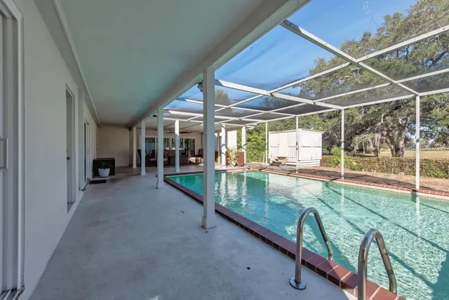 a view of a porch with furniture and floor to ceiling window