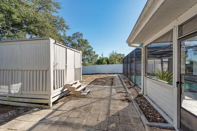 a view of backyard with wooden fence