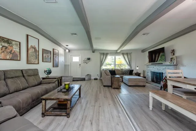 a living room with furniture flat screen tv and a fireplace